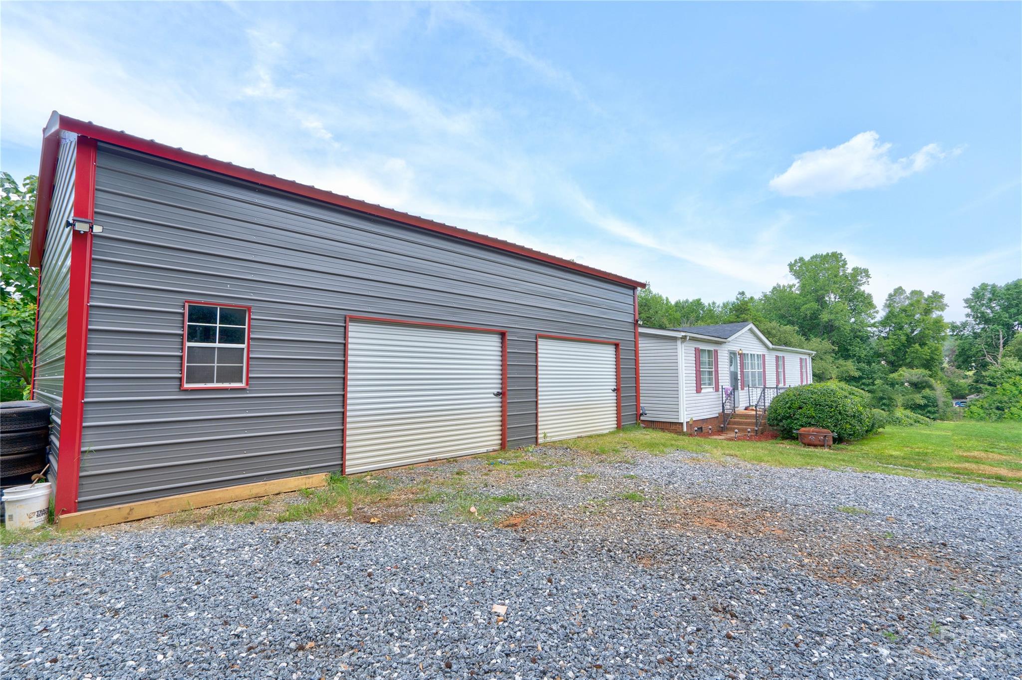 389 Shires Road Ellenboro, NC 28040 - Photo 4 of 30 a front view of a house with a yard and garage