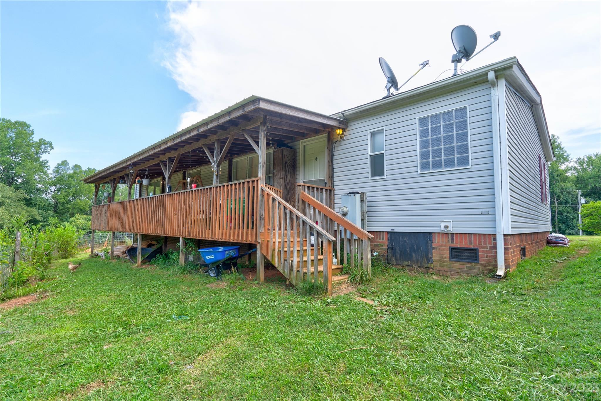 389 Shires Road Ellenboro, NC 28040 - Photo 5 of 30 a view of a house with a yard and deck