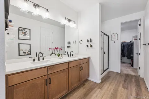 a spacious bathroom with a double vanity sink mirror and shower