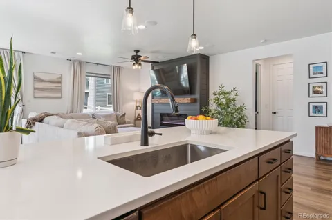 a kitchen with a sink a counter and chairs