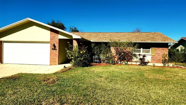 a view of a house with backyard porch and sitting area