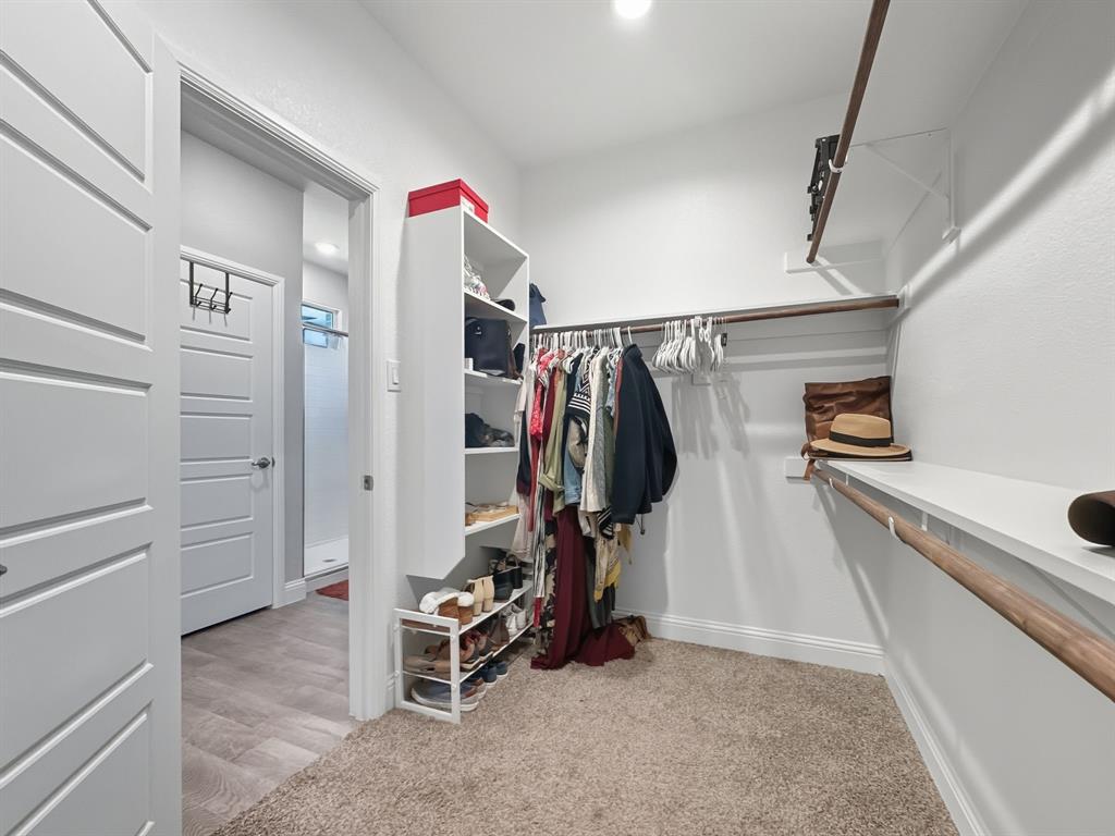 2216 Redwing Drive Denton, TX 76205 - Photo 23 of 38 a view of walk in closet with clothes and shoes