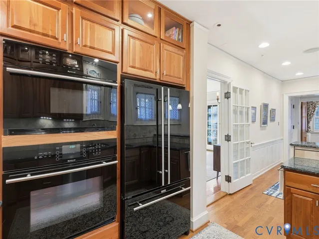 a kitchen with stainless steel appliances granite countertop a stove and cabinets
