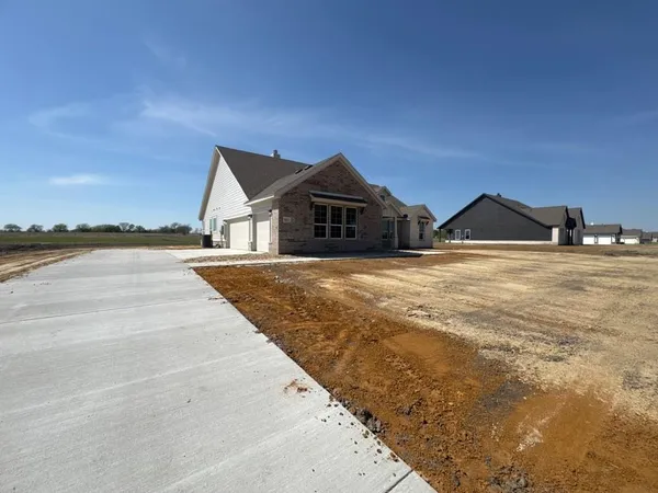a view of a house with yard and ocean view