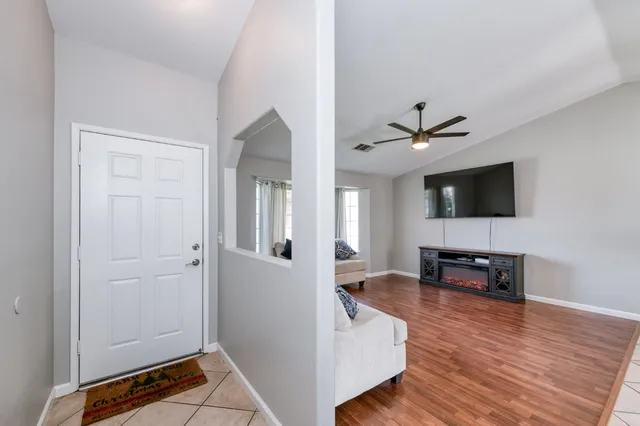 a kitchen with stainless steel appliances granite countertop a refrigerator a stove and a sink with wooden cabinets