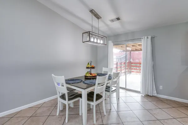 a kitchen with stainless steel appliances granite countertop a refrigerator a stove and a sink with wooden cabinets