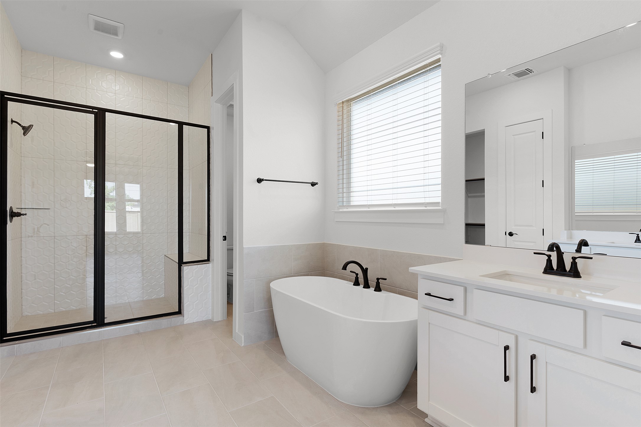 328 Ridgewell Loop Georgetown, TX 78633 - Photo 18 of 28 Bathroom with a shower stall, a freestanding tub, vanity, tile walls, and light tile patterned flooring