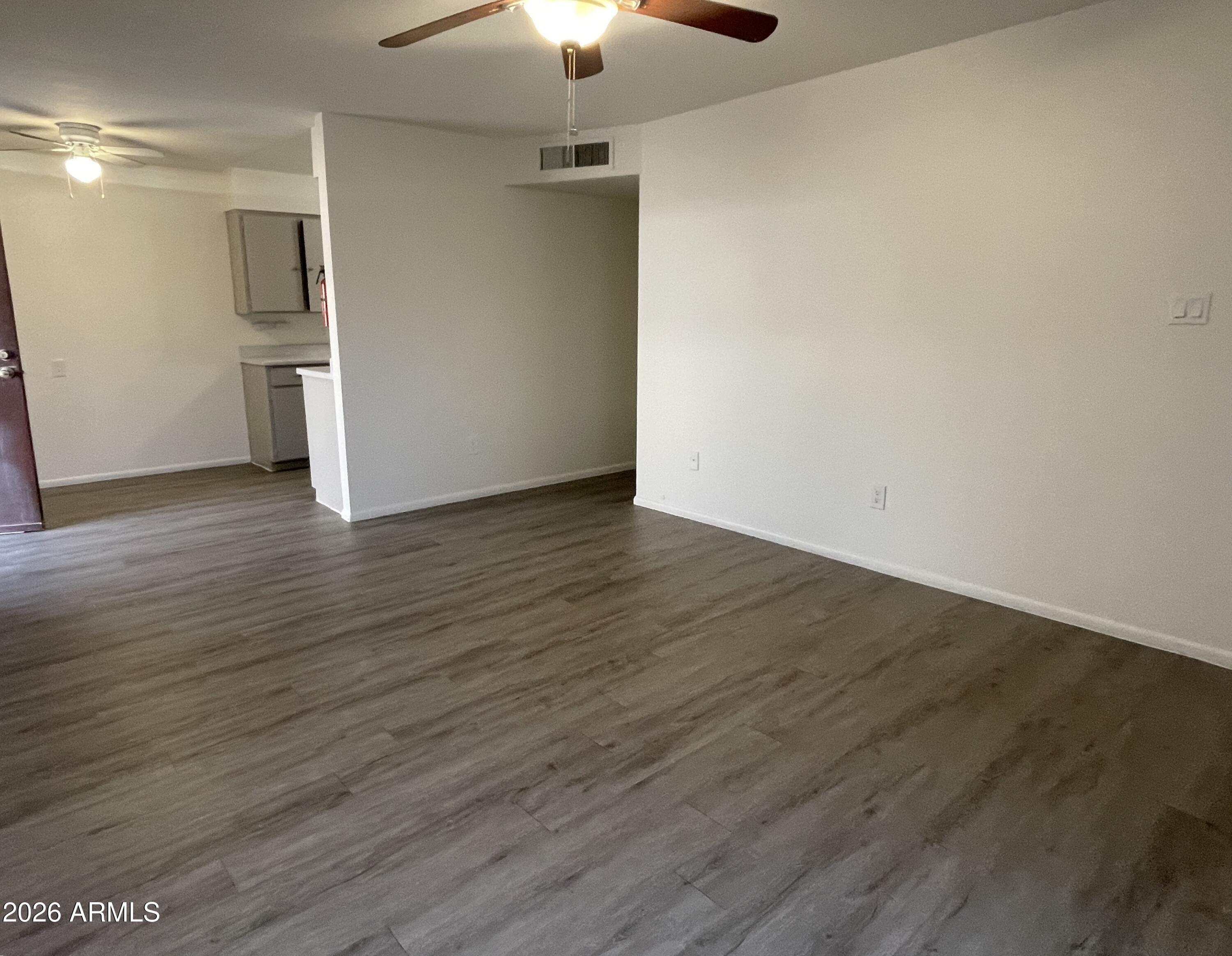 4719 North 15th Avenue, Unit 4 Phoenix, AZ 85015 - Photo 2 of 13 a view of empty room with wooden floor and ceiling fan