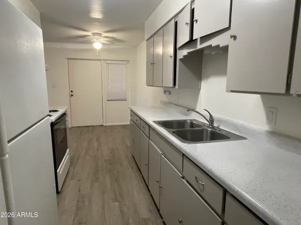 a kitchen with a sink and refrigerator