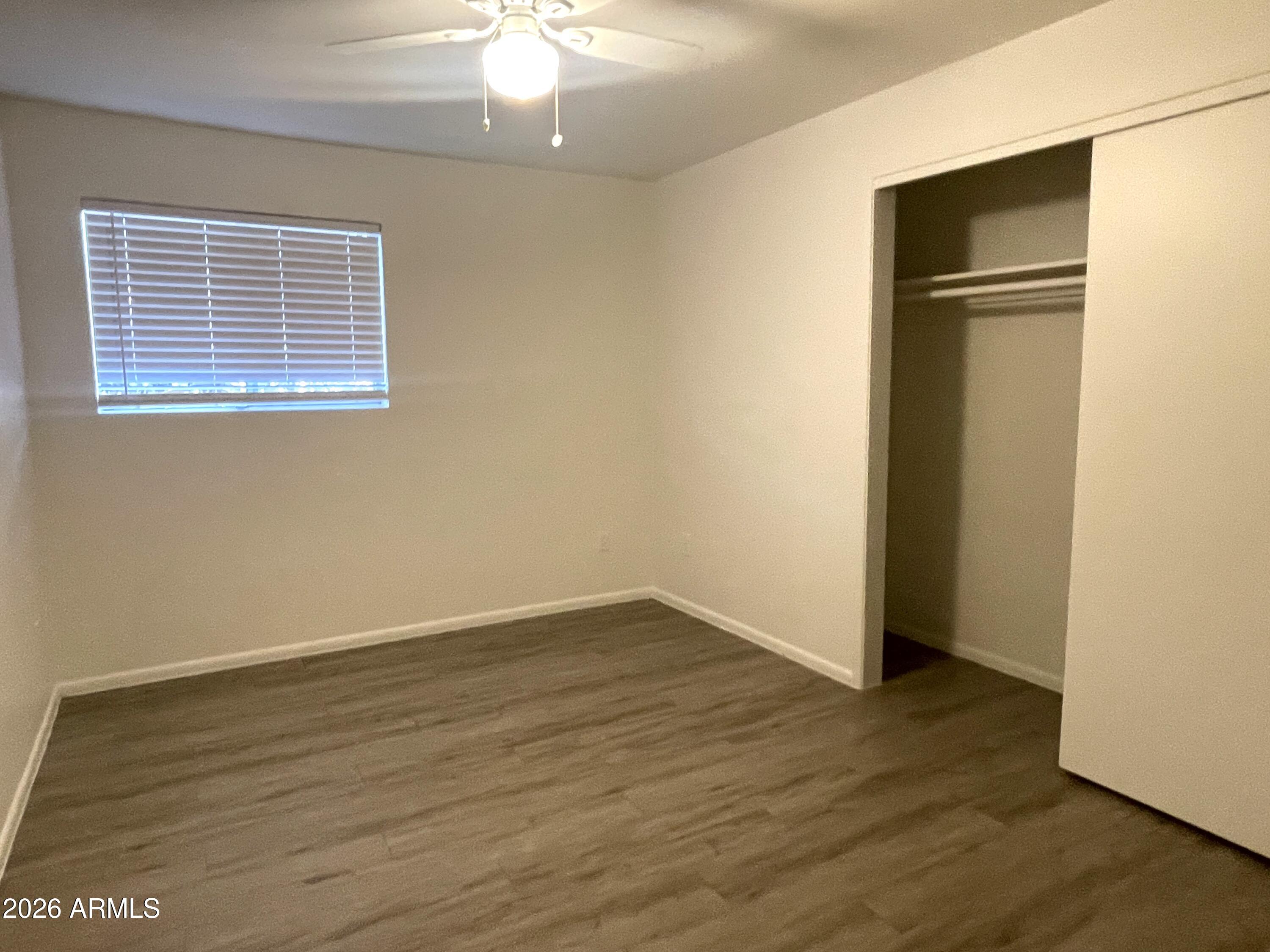 4719 North 15th Avenue, Unit 4 Phoenix, AZ 85015 - Photo 9 of 13 an empty room with wooden floor
