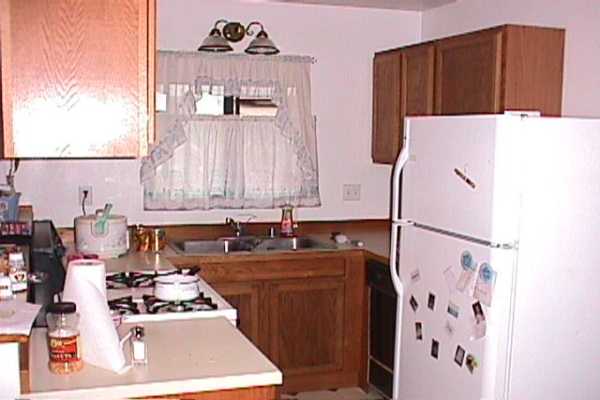277 Hookipa Road Kapaa, HI 96746 - Photo 8 of 12 a kitchen with a refrigerator a stove and a microwave