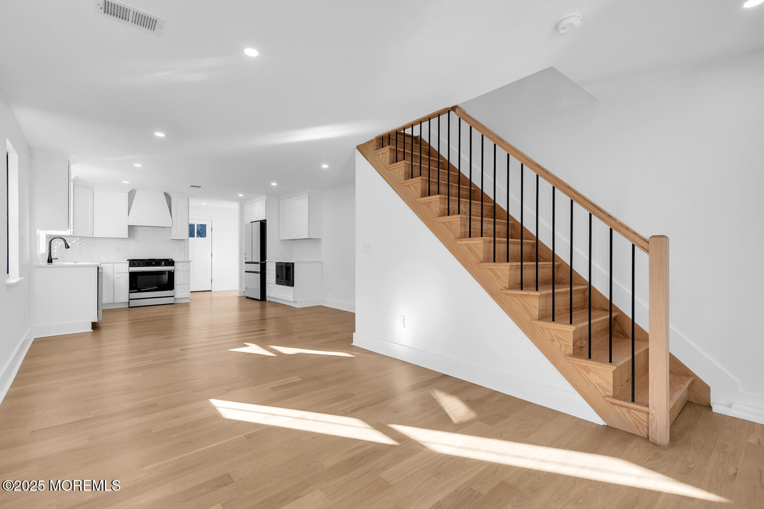 514-516 River Road Fair Haven, NJ 07704 - Photo 11 of 49 a view of a hallway with wooden floors and staircase