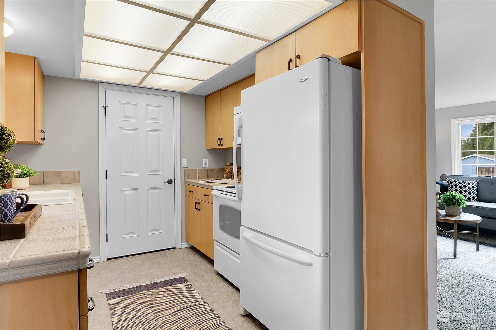 9510 Northeast 201st Street Bothell, WA 98011 - Photo 11 of 22 a white refrigerator freezer and a stove sitting inside of a kitchen