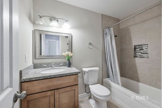 240 West Benson Avenue Ridgecrest, CA 93555 - Photo 16 of 29 a bathroom with a granite countertop sink toilet and shower