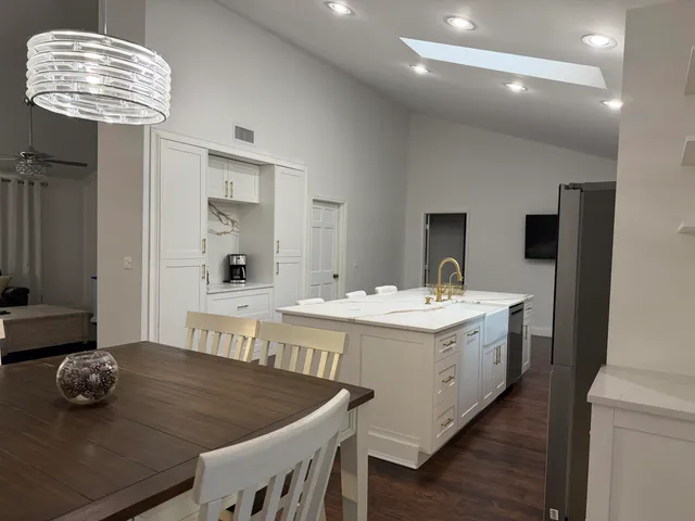 a kitchen that has a sink and a table in it