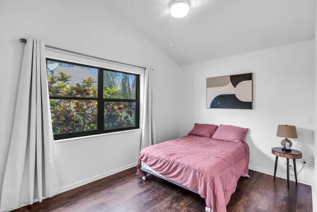 a bedroom with a bed and a large window