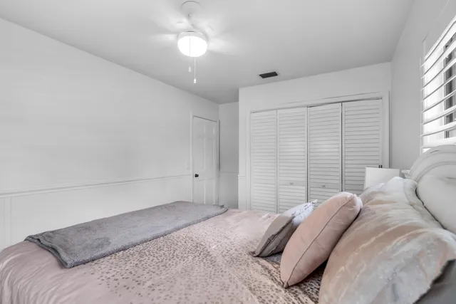 a bedroom with a large bed and a large window