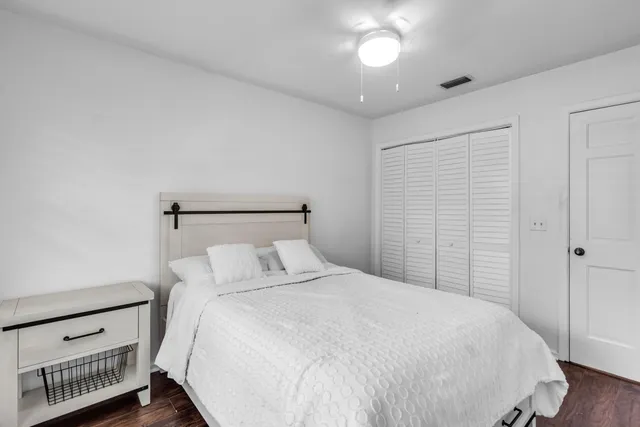 a bedroom with a bed and a night stand