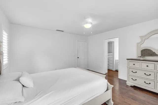 a bedroom with a bed and a dresser