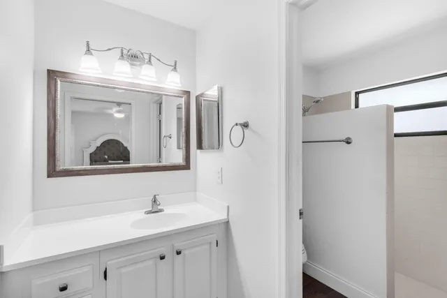 a bathroom with a sink a mirror and a shower