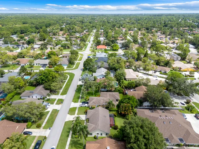 an aerial view of residential houses with outdoor space and city view
