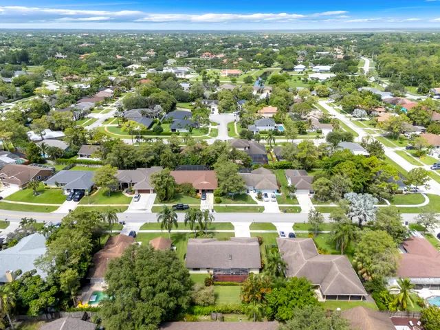 an aerial view of residential building with yard