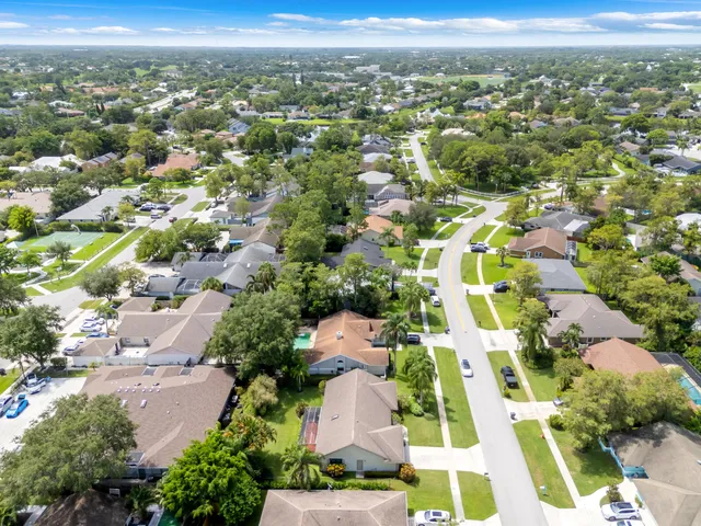 an aerial view of a house with a yard