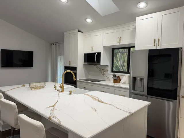 a kitchen with a sink a microwave and refrigerator