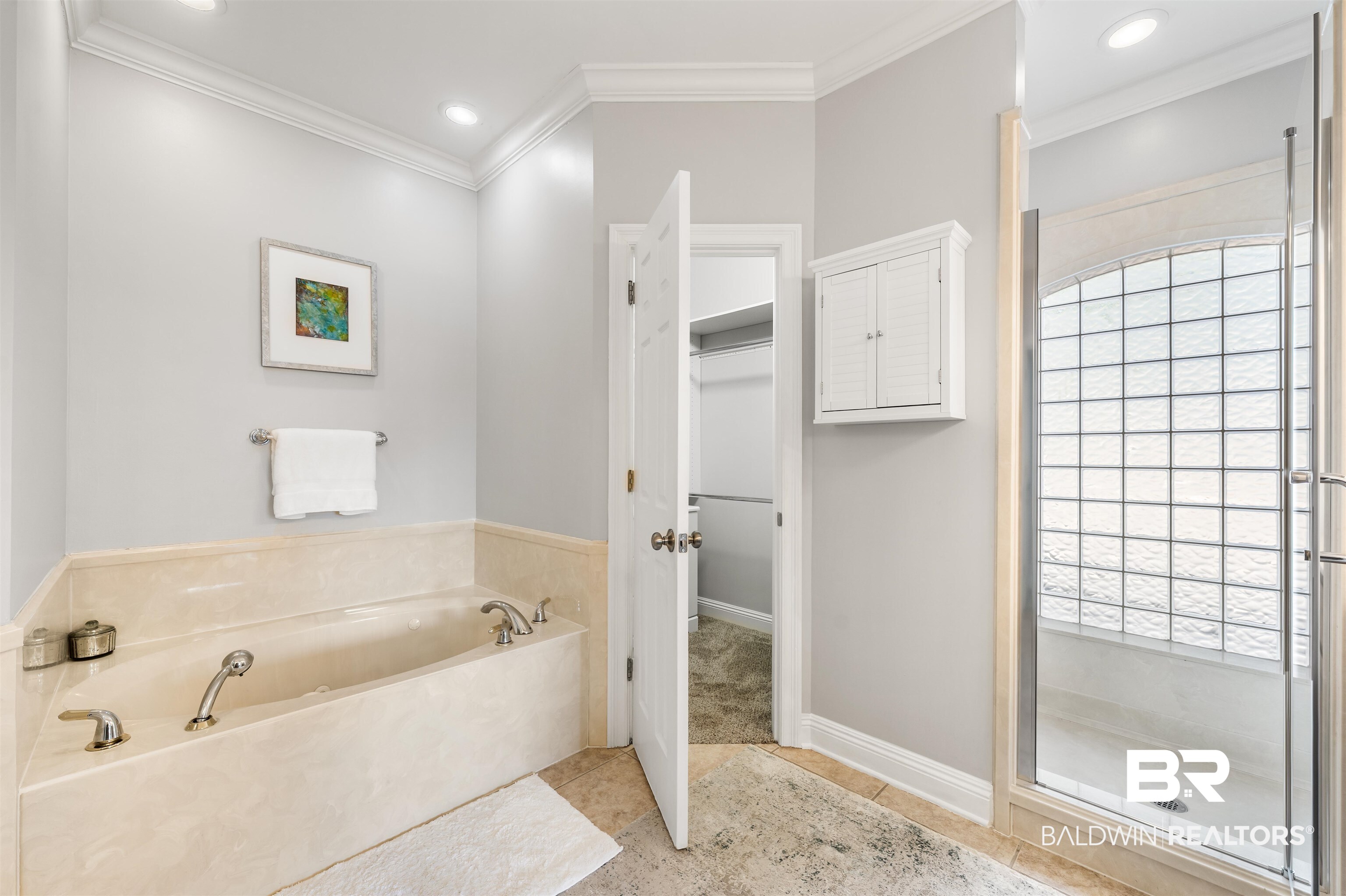 19079 Baldwin County Road 10 Foley, AL 36535 - Photo 24 of 37 Bathroom featuring a bath, crown molding, a spacious closet, light tile patterned floors, and recessed lighting