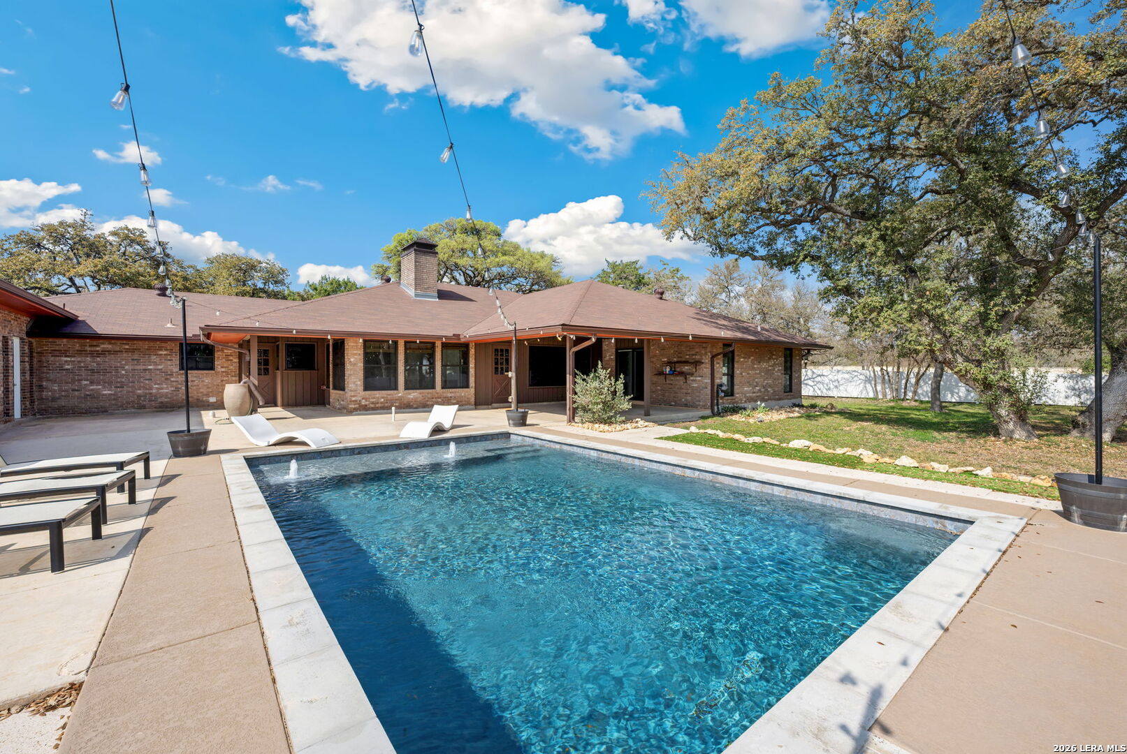 a view of a house with swimming pool and a yard