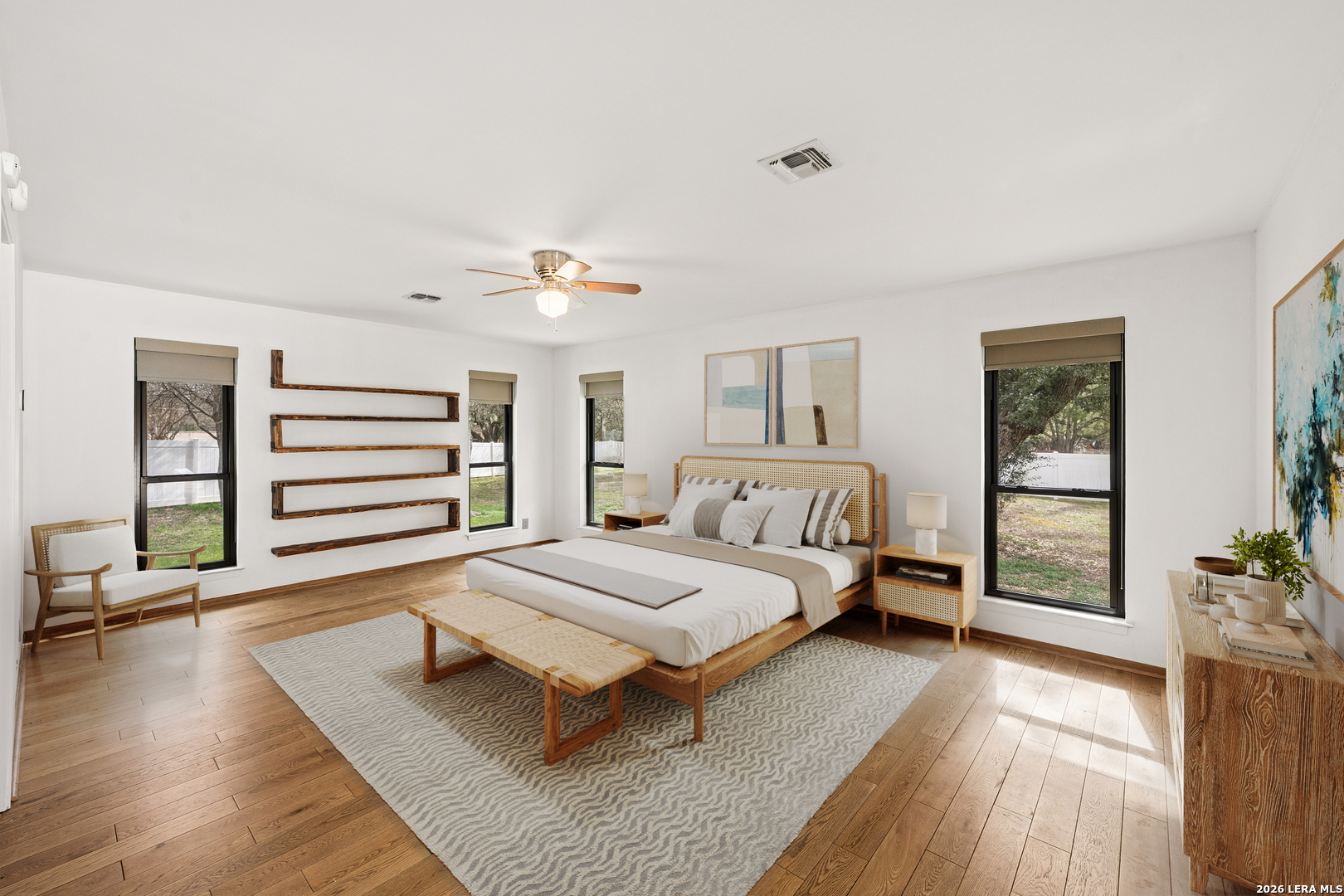 9616 Azalea Circle Garden Ridge, TX 78266 - Photo 11 of 47 a bedroom with a bed and wooden floor