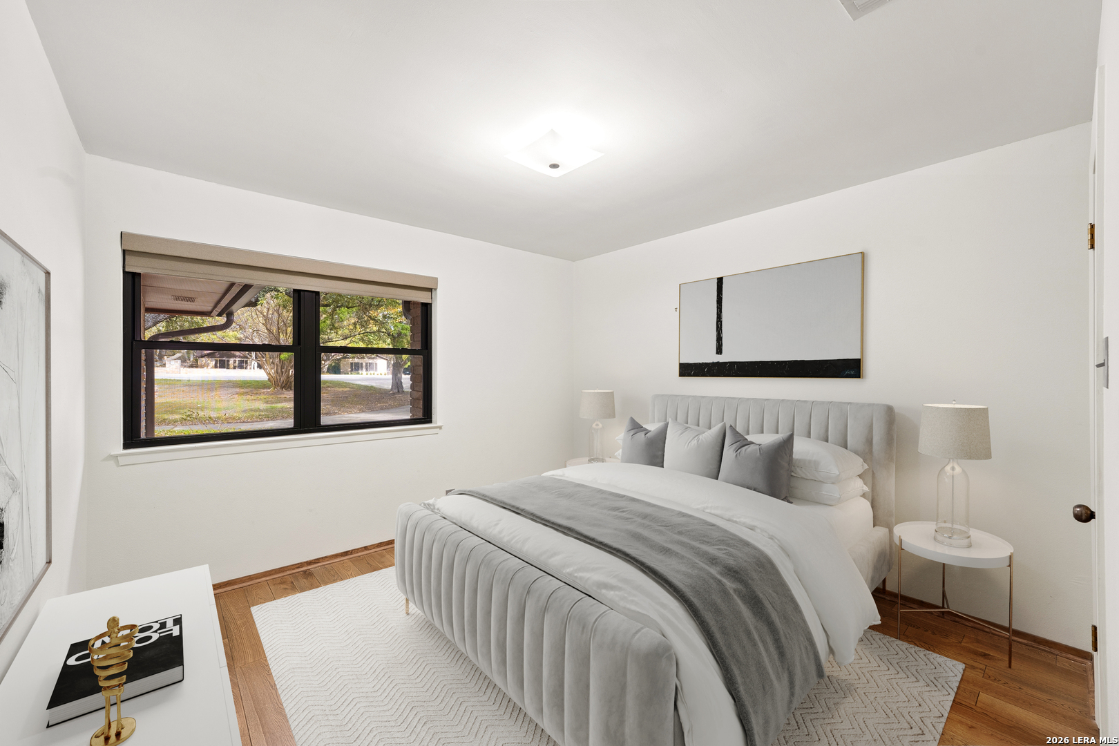 9616 Azalea Circle Garden Ridge, TX 78266 - Photo 13 of 47 a bedroom with a bed and a lamp on dresser