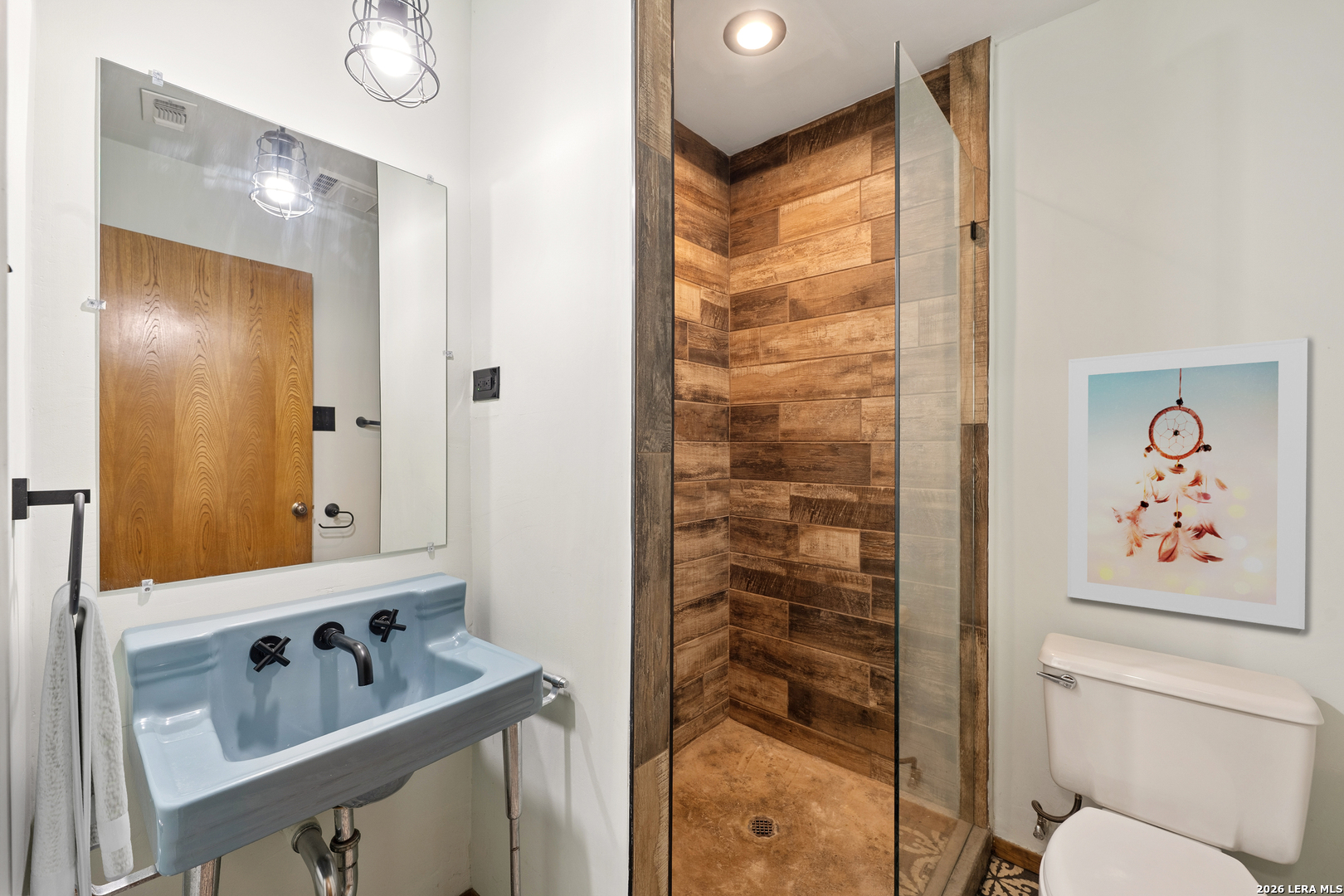 9616 Azalea Circle Garden Ridge, TX 78266 - Photo 14 of 47 a bathroom with a shower sink and mirror with toilet