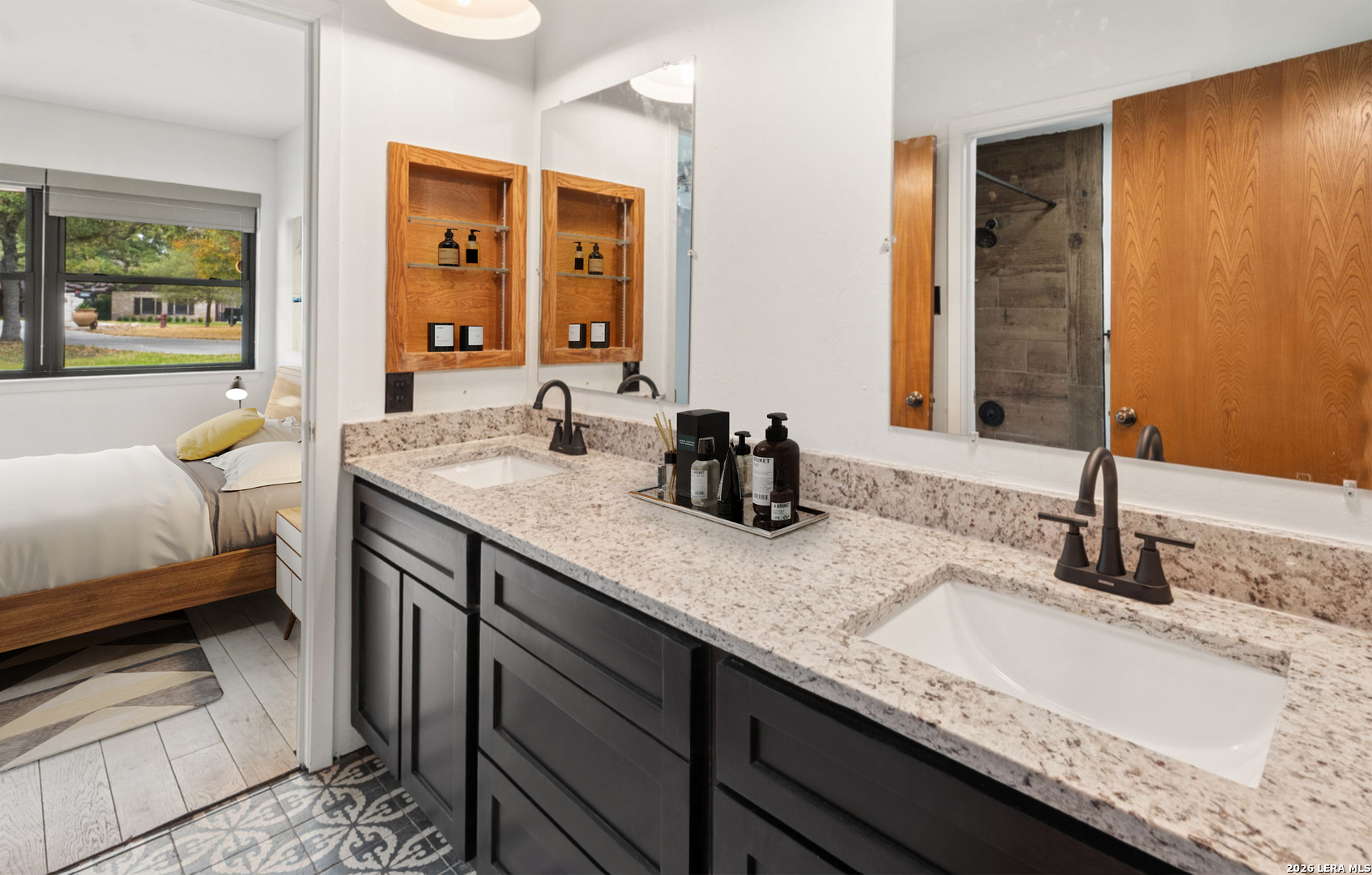 9616 Azalea Circle Garden Ridge, TX 78266 - Photo 16 of 47 a bathroom with a granite countertop sink and a mirror