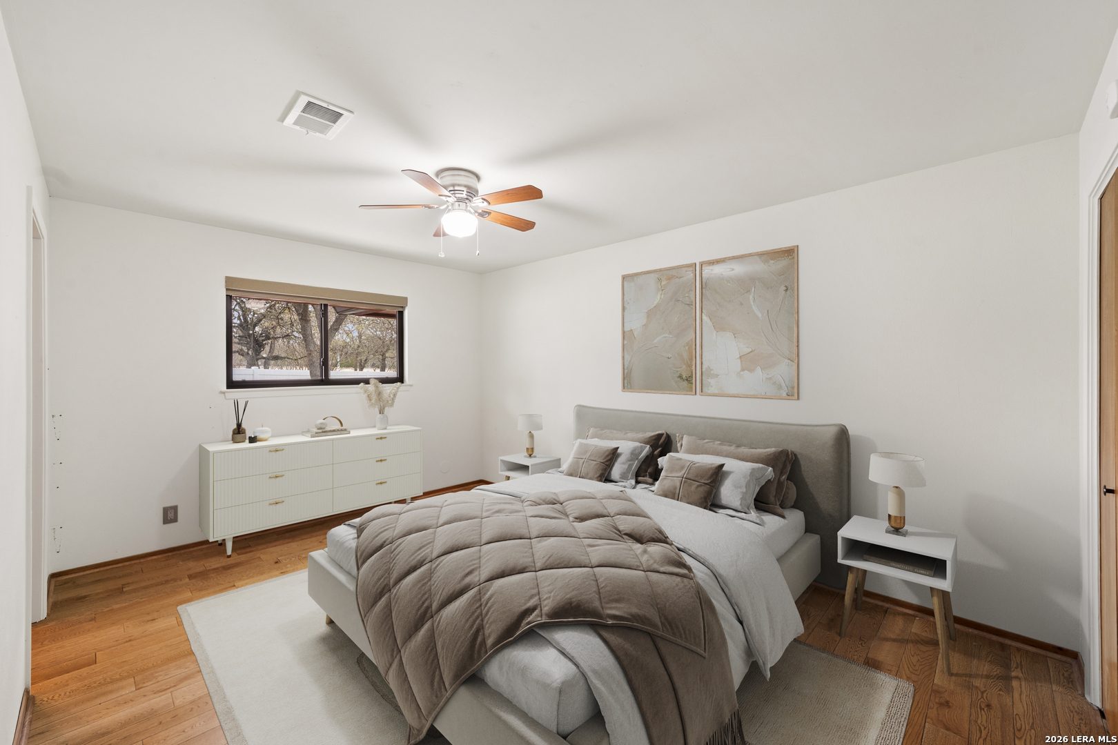 9616 Azalea Circle Garden Ridge, TX 78266 - Photo 17 of 47 a bedroom with a bed and a painting on the wall