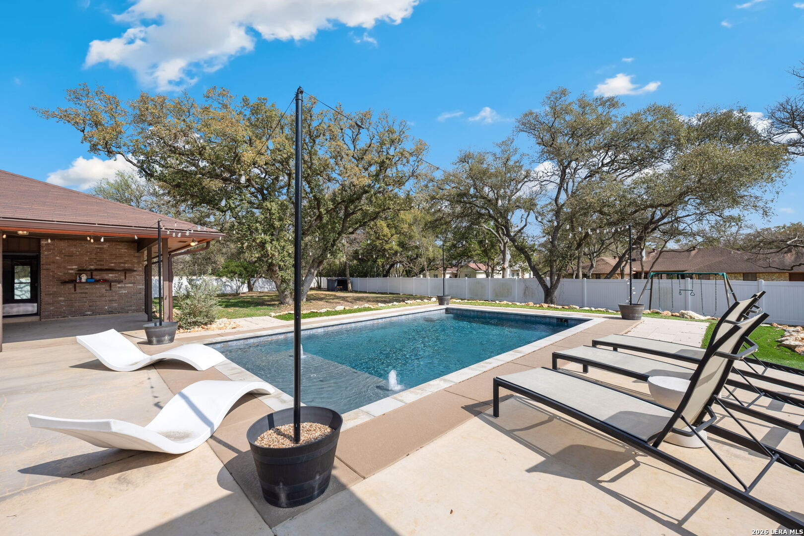 9616 Azalea Circle Garden Ridge, TX 78266 - Photo 3 of 47 a view of a patio with a dining table and chairs with wooden floor and fence