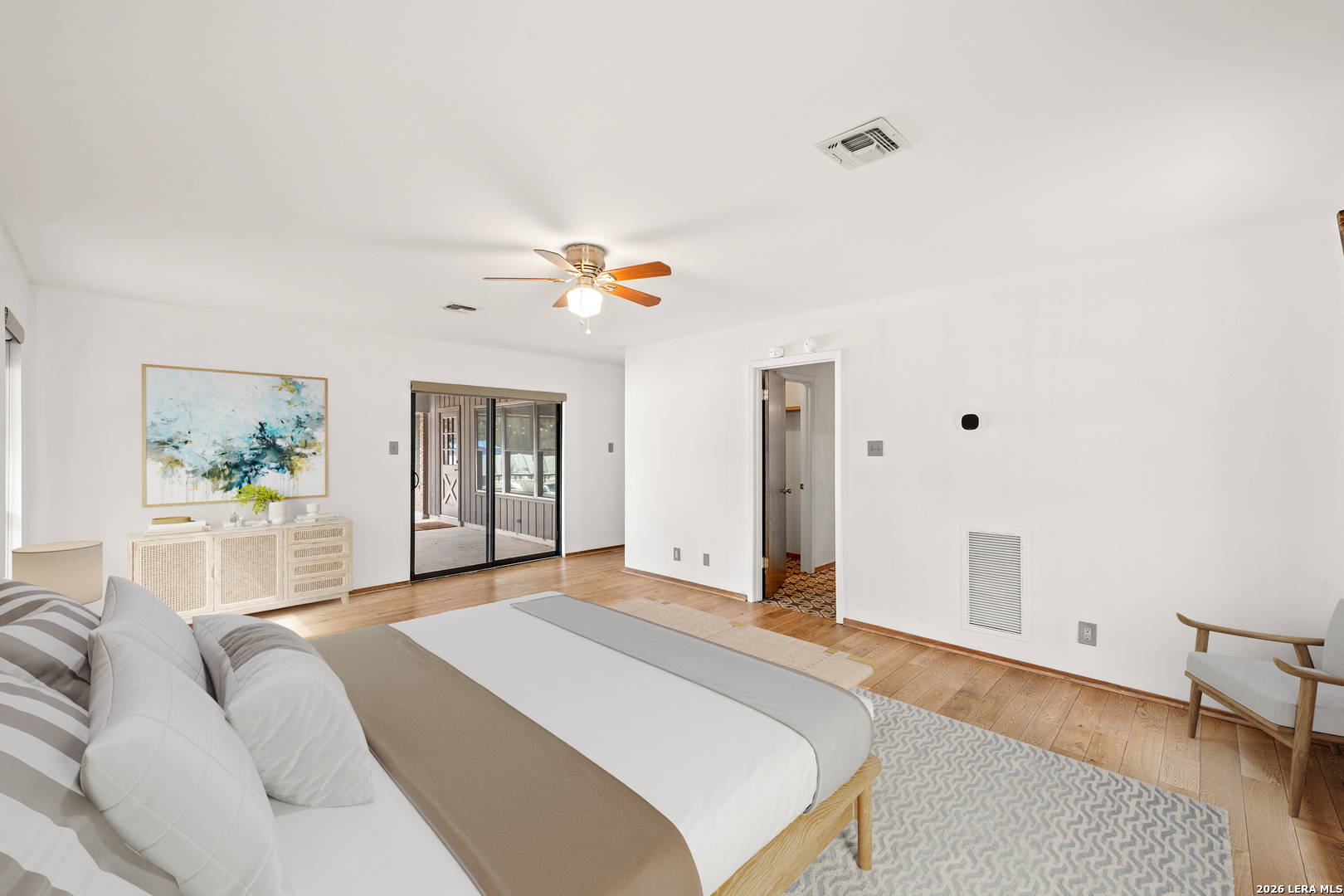 9616 Azalea Circle Garden Ridge, TX 78266 - Photo 39 of 47 a bedroom with a bed and a chandelier