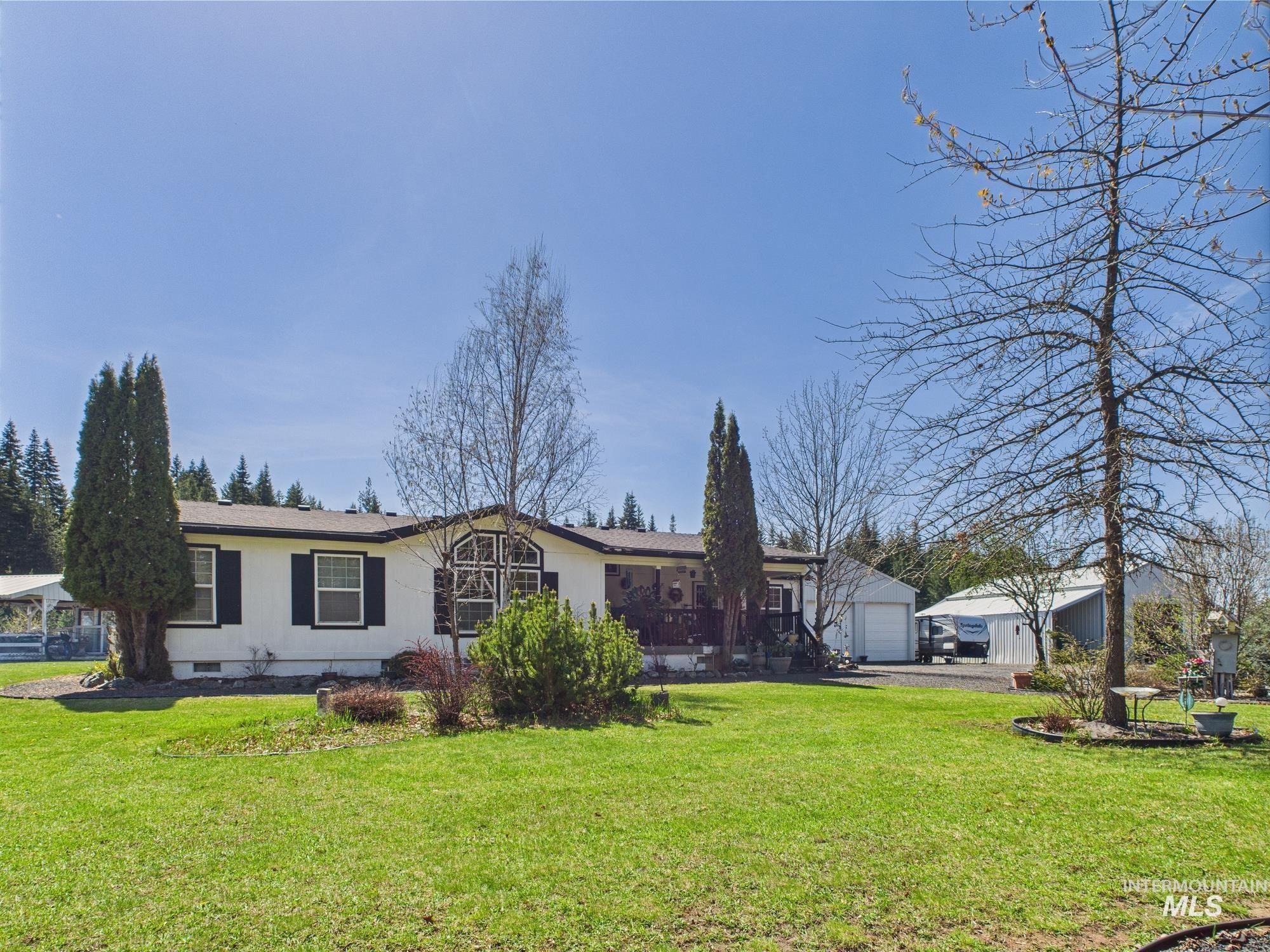 254 Lackey Road Weippe, ID 83553 - Photo 5 of 38 Ranch-style house featuring crawl space, a front lawn, a wooden deck, and an outdoor structure