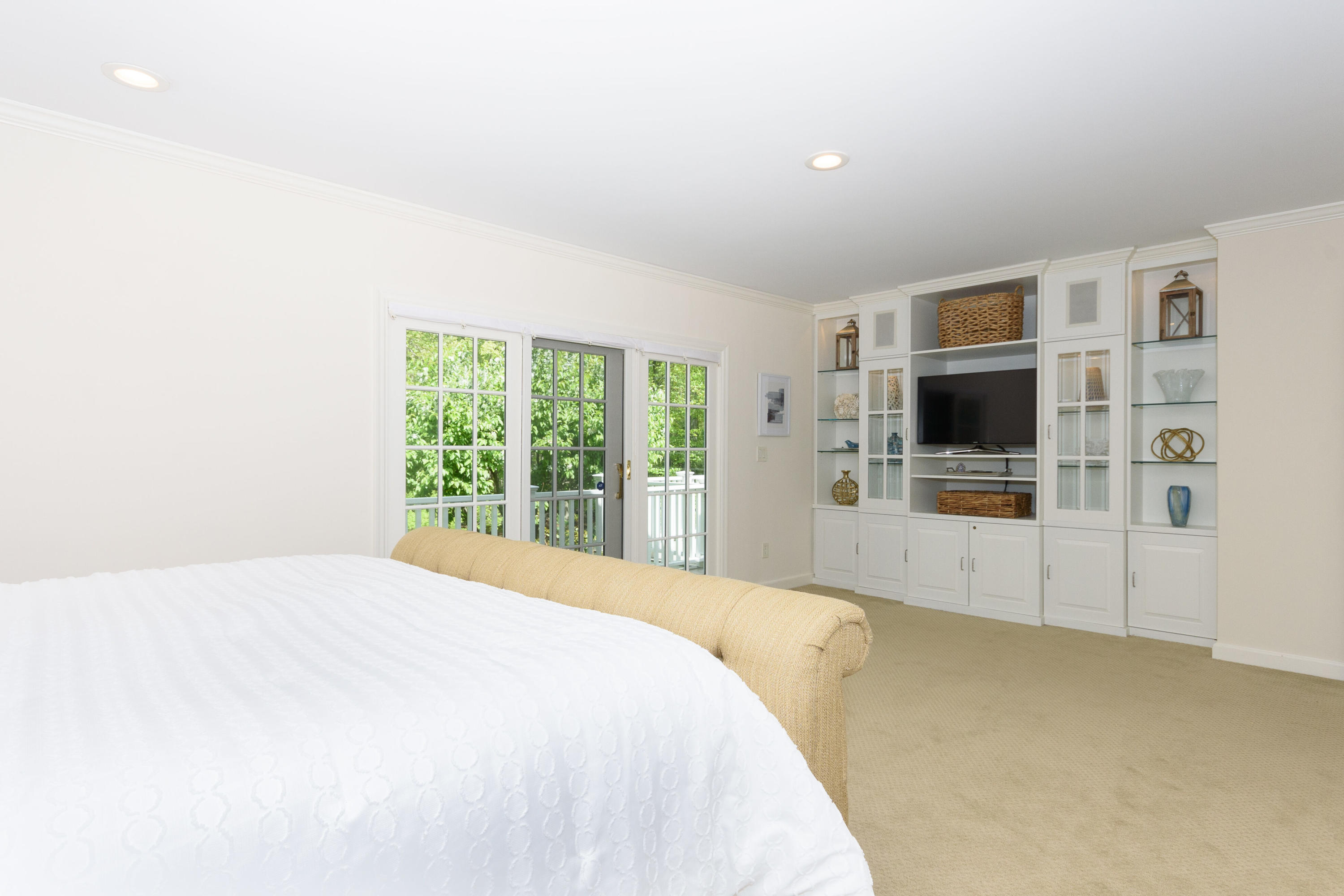 116 Ridge Acres Road Darien, CT 06820 - Photo 20 of 44 a spacious bedroom with a large bed and a flat tv screen