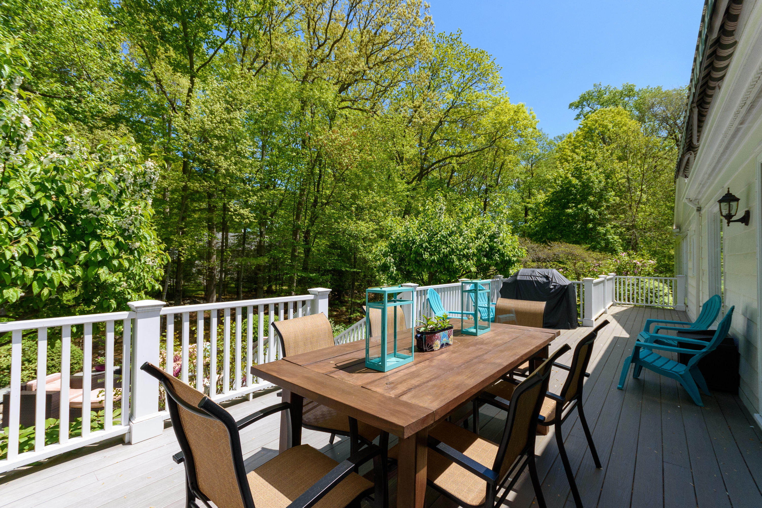 116 Ridge Acres Road Darien, CT 06820 - Photo 35 of 44 a view of a dining table and chairs on the roof deck