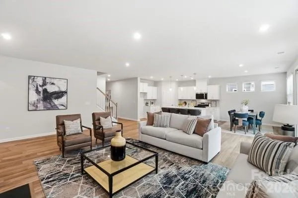 a living room with furniture a large window and a fireplace