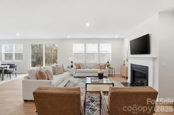 a living room with a fireplace a flat screen tv and a fireplace