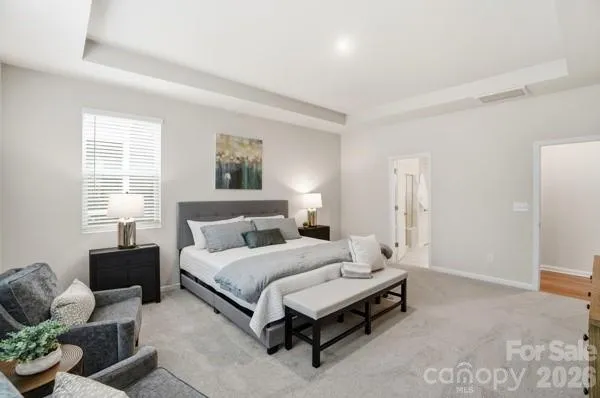 a spacious bedroom with a bed and a couch