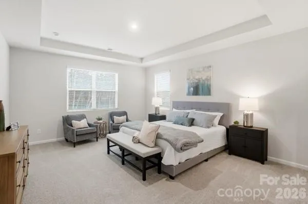 a en suite bathroom with 2 sink flowerpot and a mirror