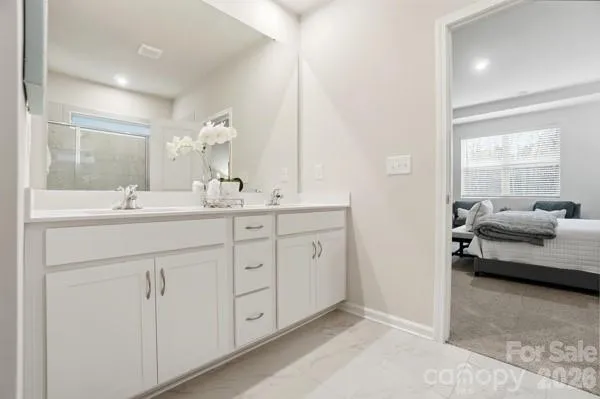 a bathroom with a glass shower door