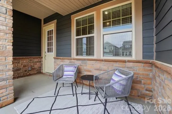 a view of a porch with furniture and garden