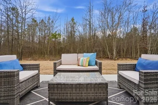 a backyard of a house with table and chairs