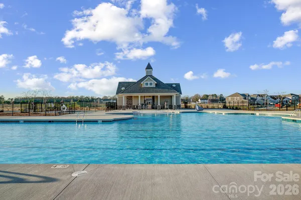 a view of a swimming pool and a yard