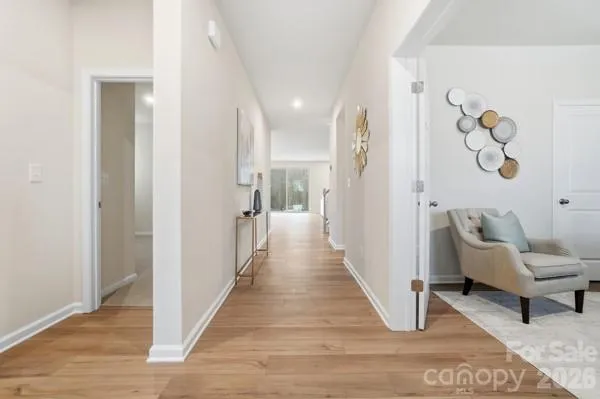 a kitchen with stainless steel appliances kitchen island granite countertop a dining table chairs and white cabinets