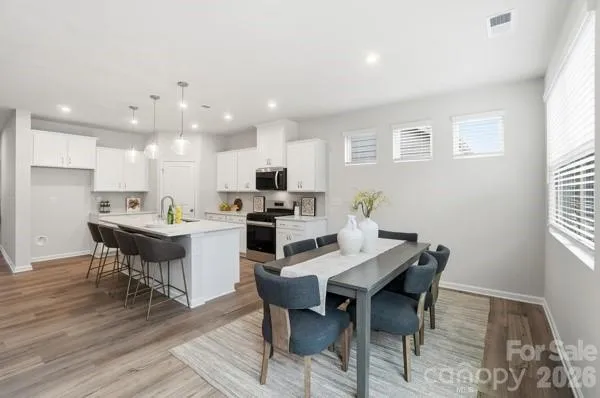 a view of a dining room with a table and chairs